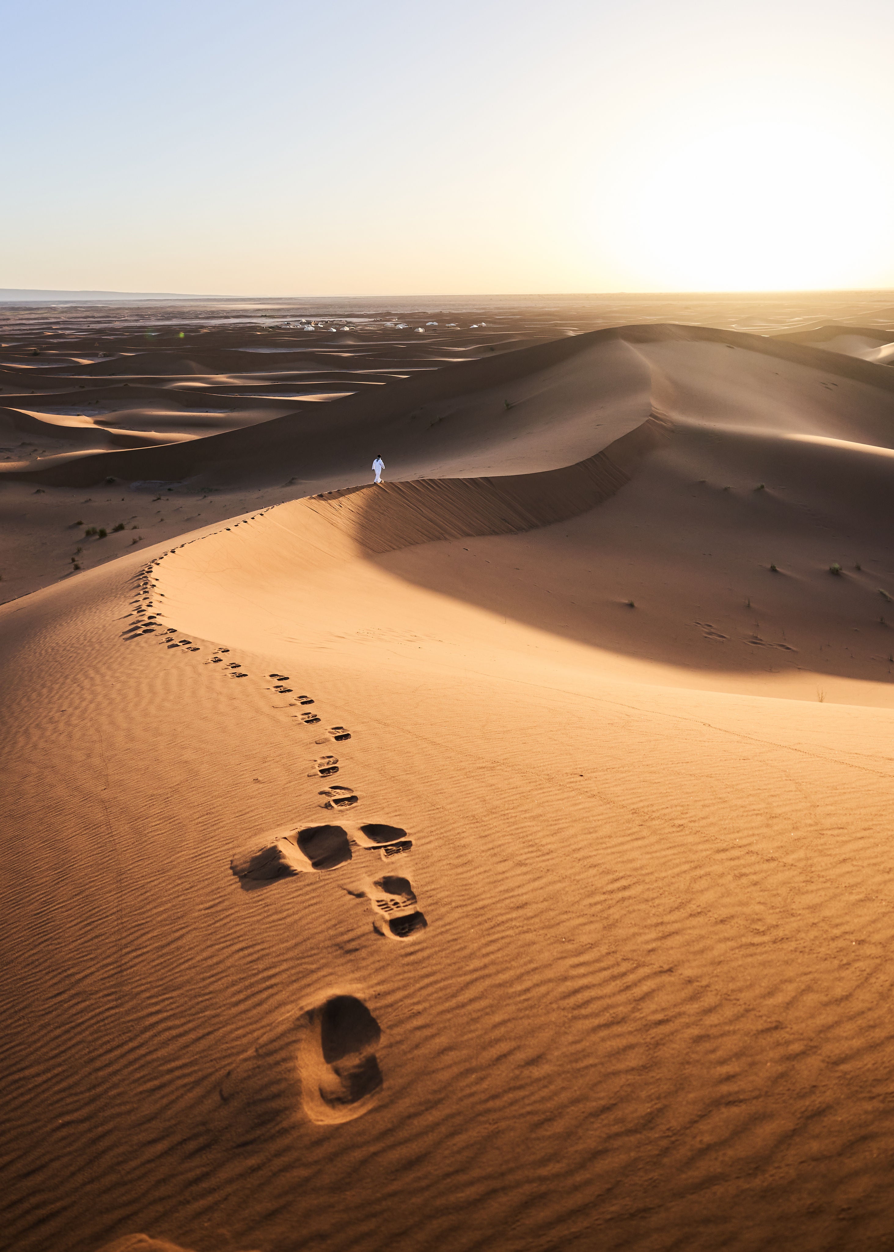 Man walking alone in a desert in morocco