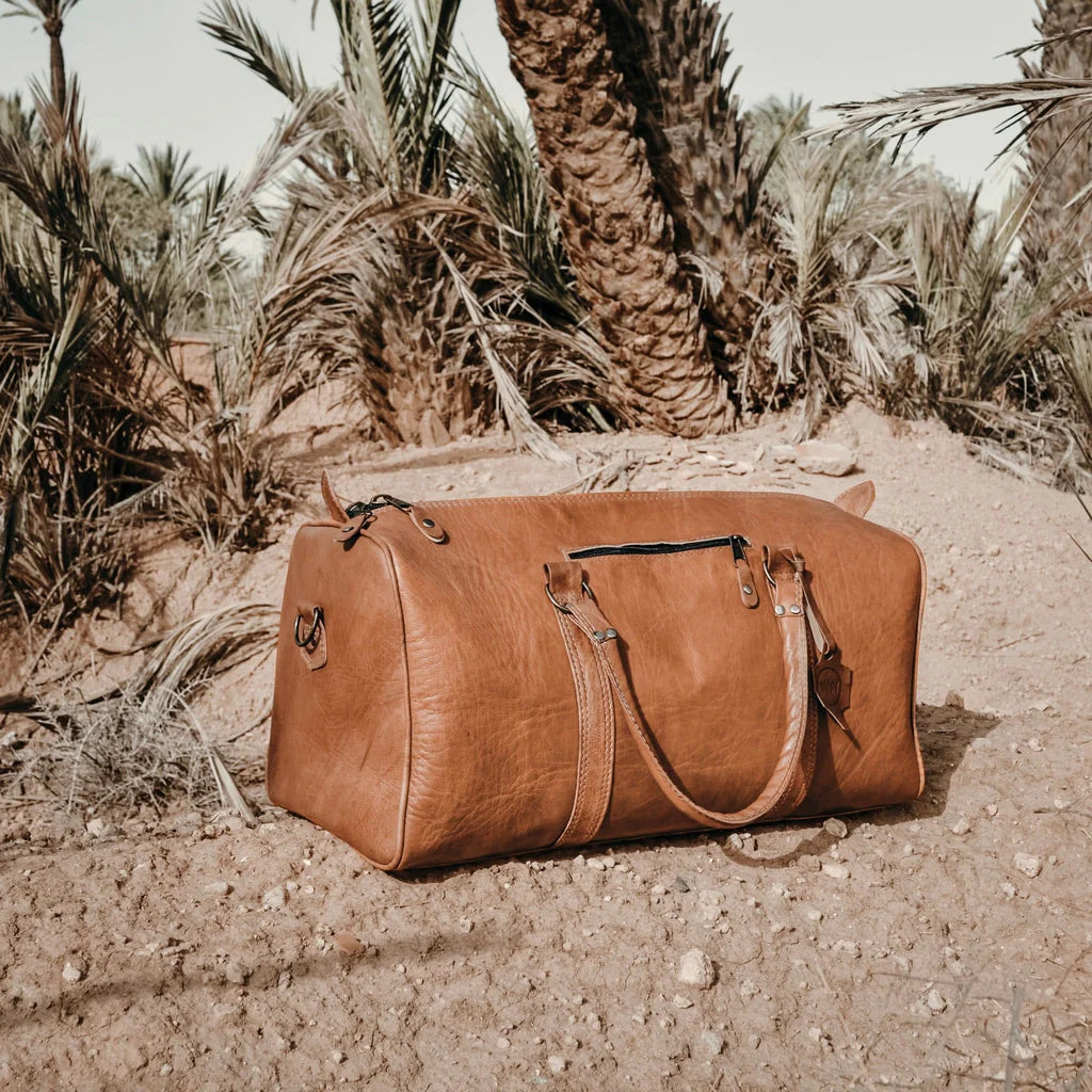 he Berber Weekender Travel Bag: A true symbol of Moroccan artistry, expertly handcrafted using 100% chemical-free goat leather.  Timeless Elegance: Embrace the timeless elegance of the Berber Weekender Travel Bag, a stylish companion that blends functionality with sophistication.