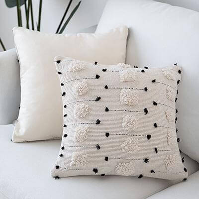 Nordic White Pillow with Pom-Poms: Scandinavian charm, Handcrafted elegance, Textured accents, Cozy comfort, Minimalist decor, Whimsical details.