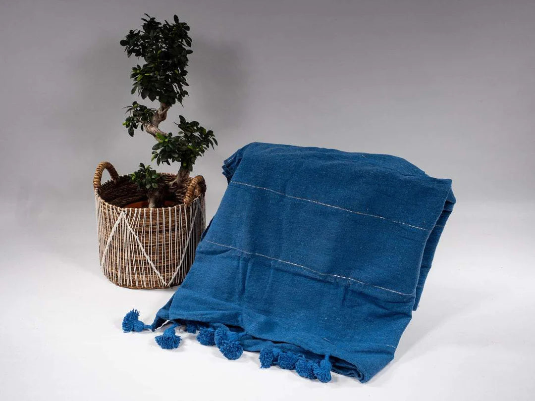 Moroccan Berber blue Pom Pom Blanket: Cultural treasure. The Moroccan Berber Handmade Pom Pom Blanket is a cherished piece that represents the rich cultural heritage and traditions of the Berber people in Morocco.